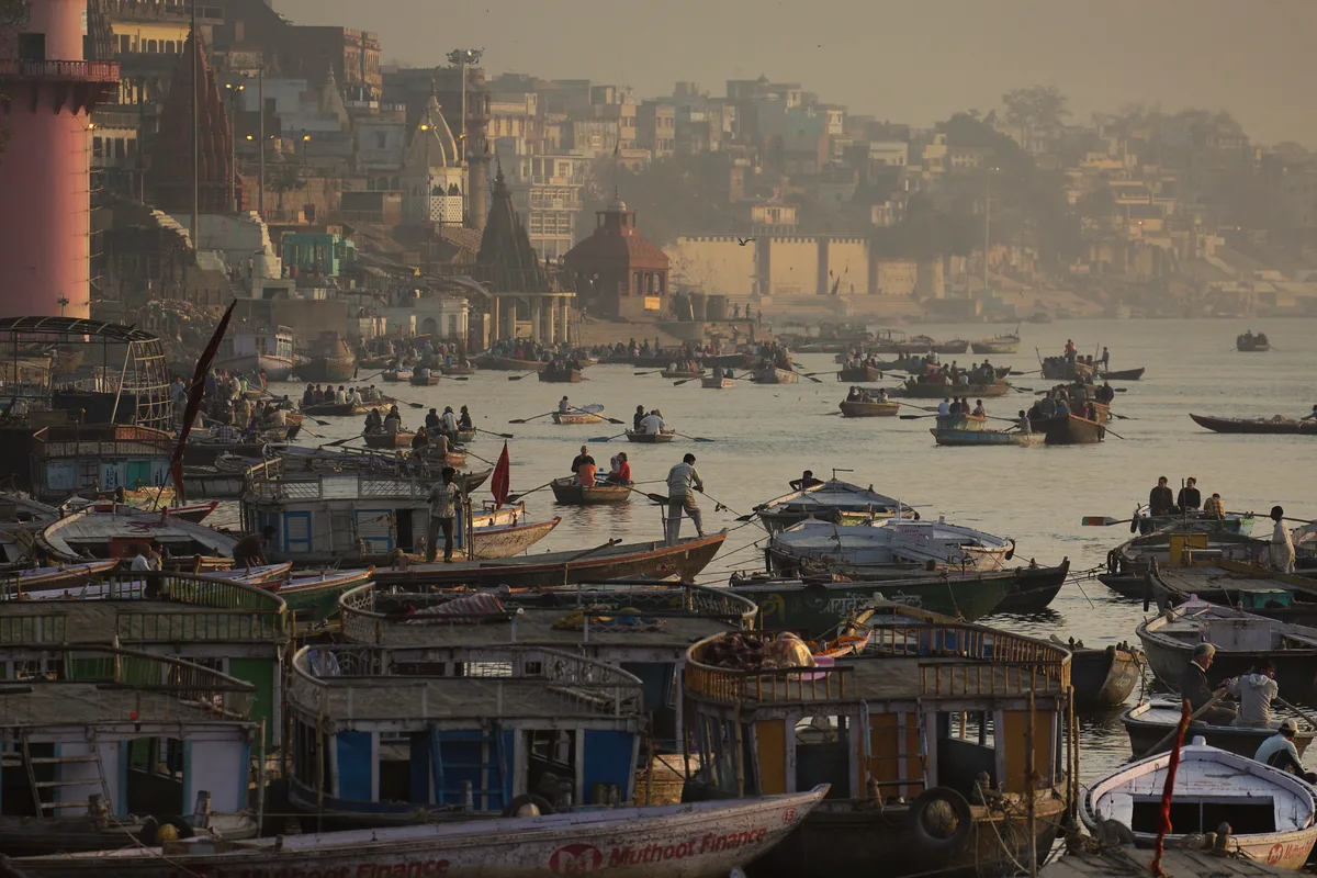 Scindia Ghat at dawn — the partially submerged Shiva temple visible in the Ganga, Varanasi